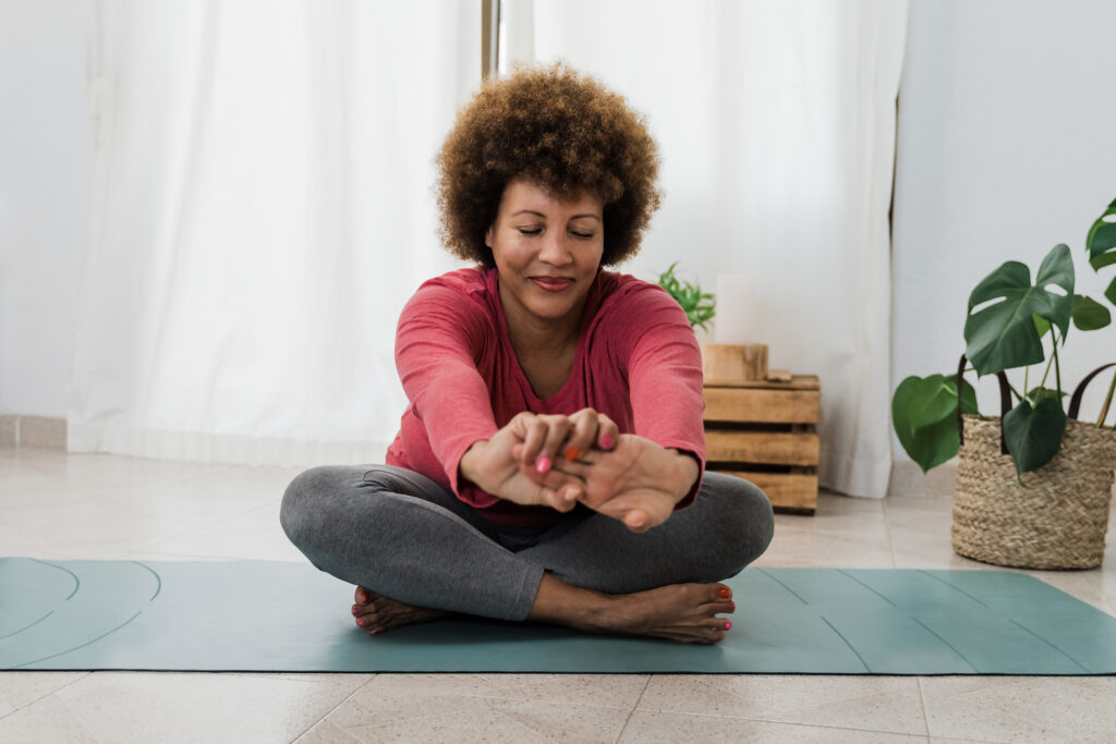 Senior woman doing yoga at home